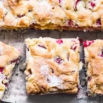 Rhubarb cake recipes squares with a golden crust and dusted with powdered sugar